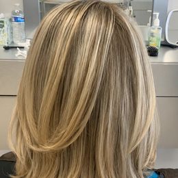 Gray blended through blonde at shoulder length, so it grows out without a line