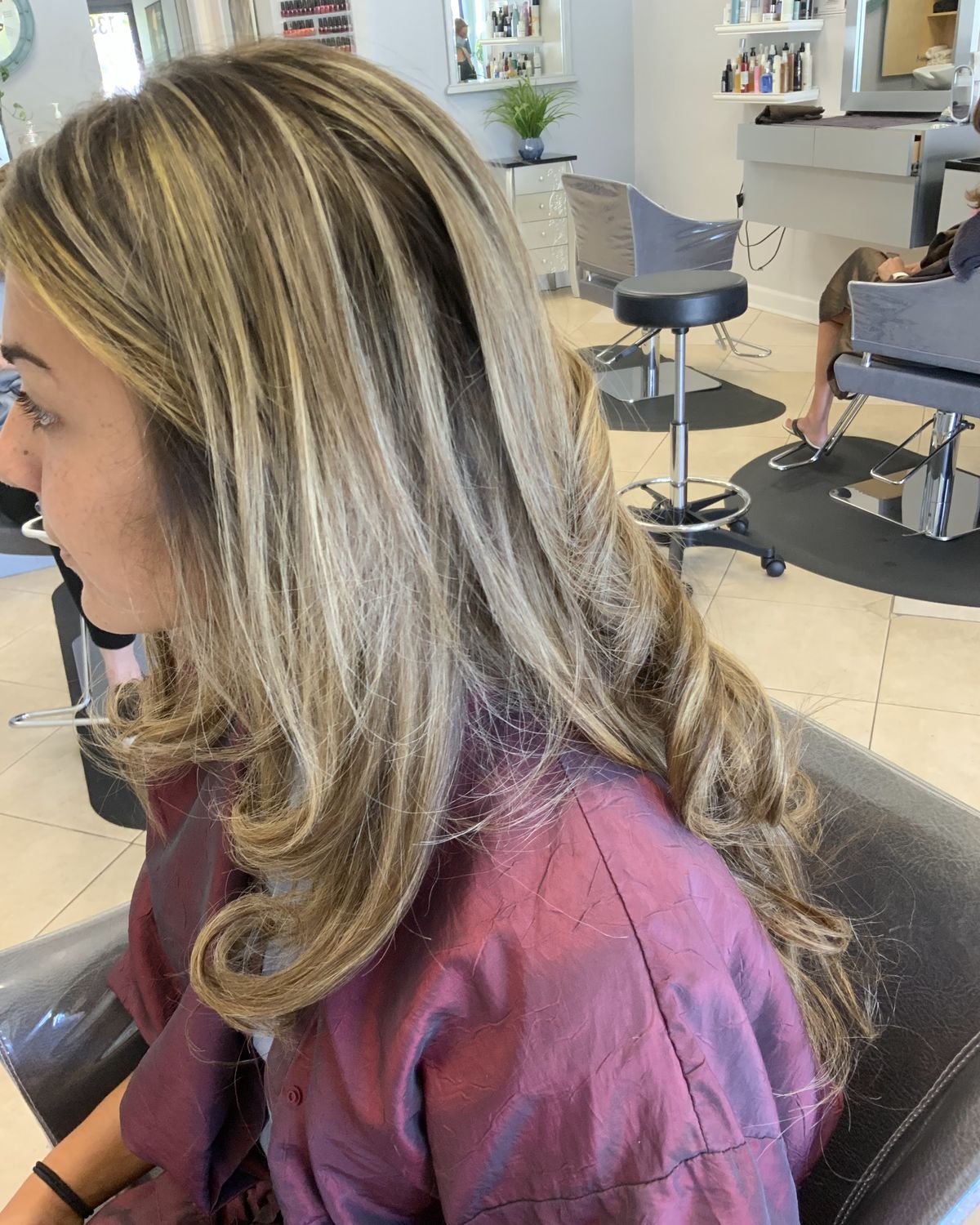 Dimensional blonde with a soft curl — Toucheé Organic Salon, Juno Beach