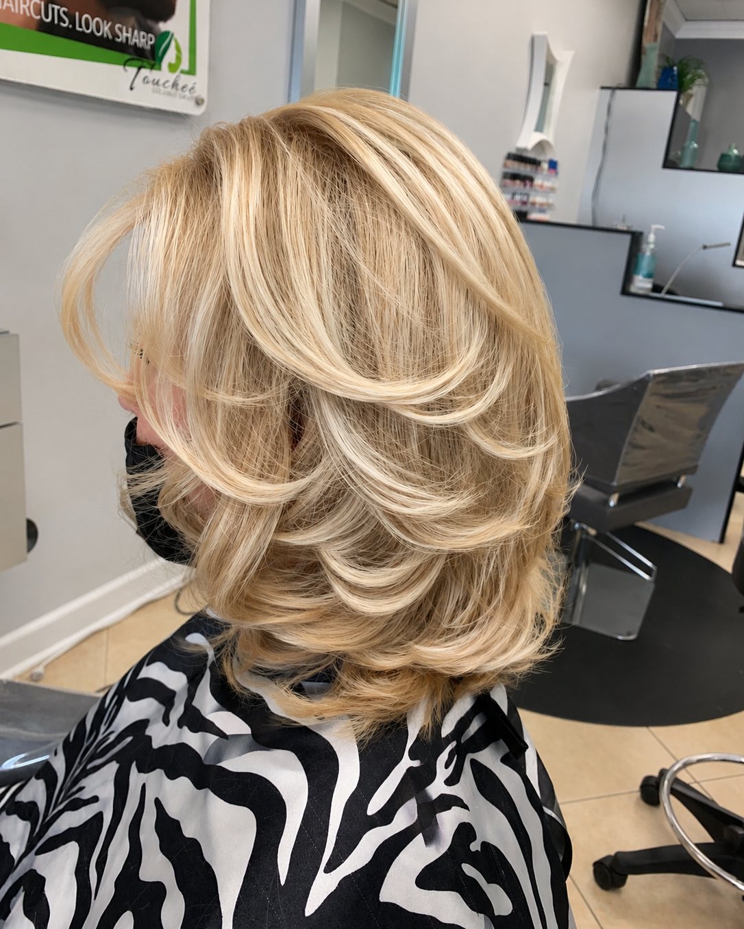 Bright blonde lob cut into layers and curled out &mdash; Touche&eacute; Organic Salon, Juno Beach