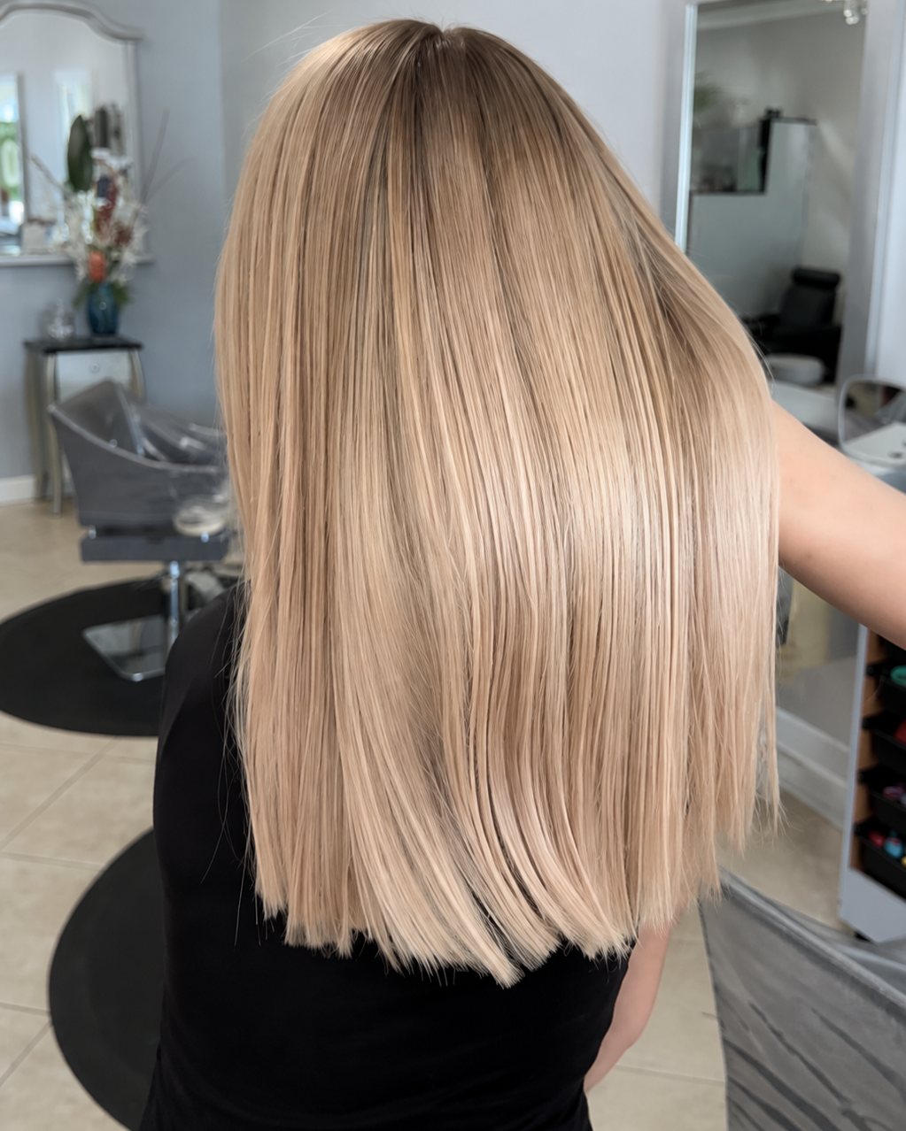 Long blonde with a soft shadowed root, worn straight &mdash; Touche&eacute; Organic Salon, Juno Beach