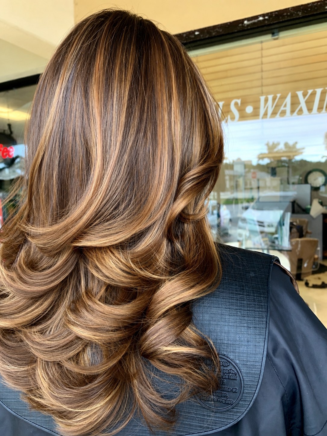 Caramel and honey dimension through brunette, finished with a soft curl