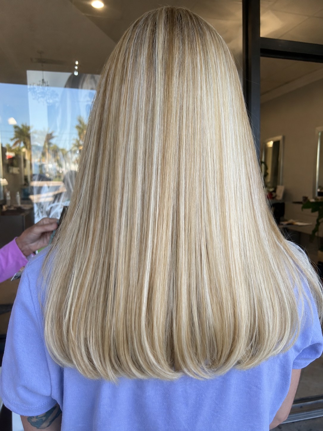 Long golden blonde blow-dried straight, cut to one soft line