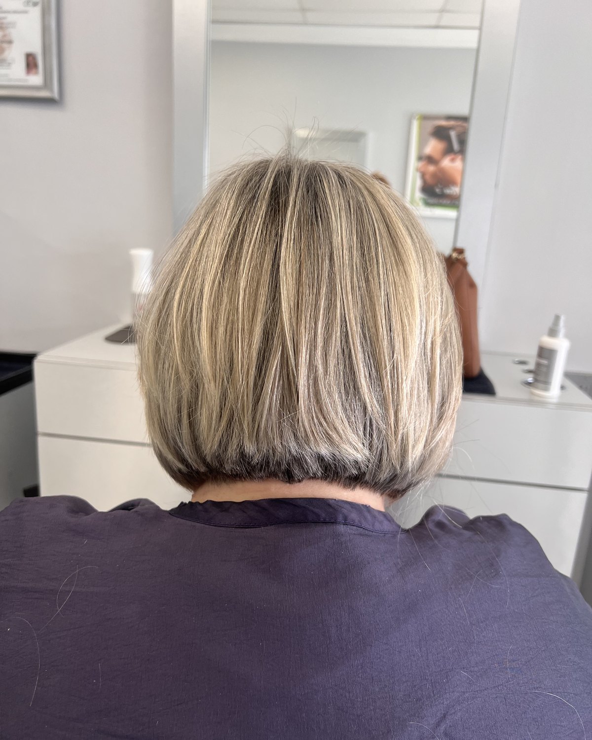 Gray blended through blonde rather than covered over &mdash; the grow-out has no line in it