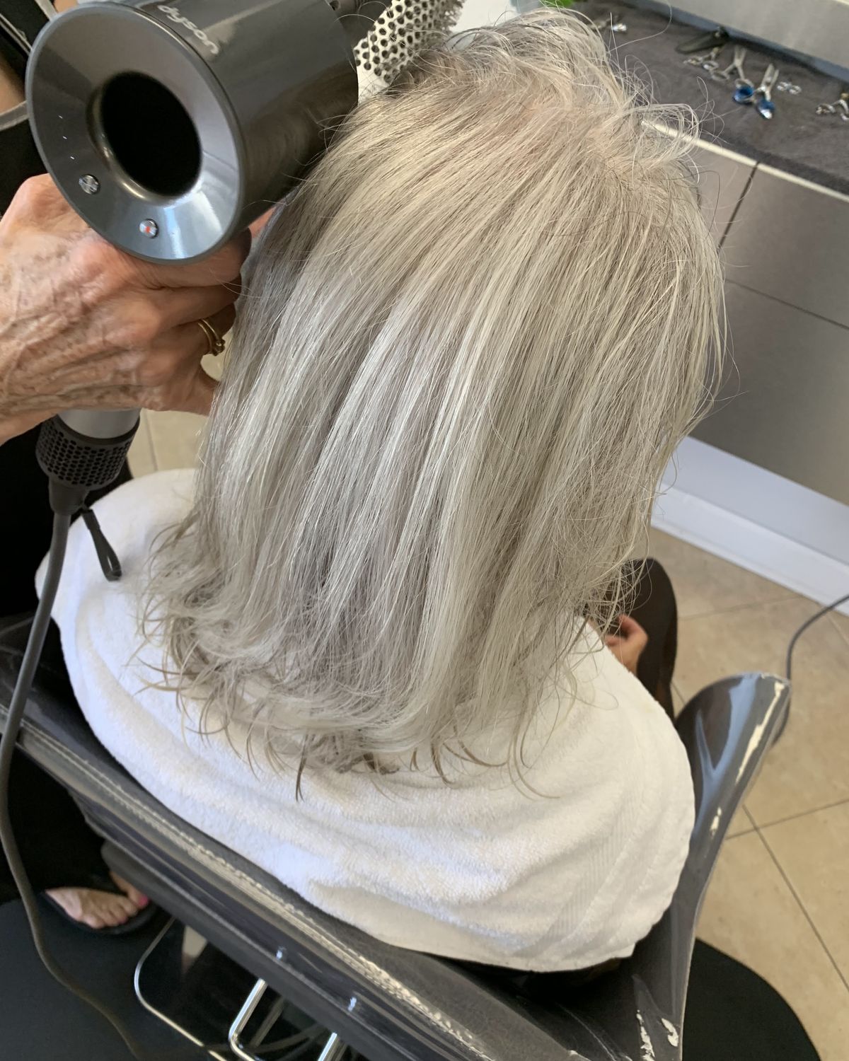 Platinum blonde being dried mid-service at Touchée Organic Salon in Juno Beach