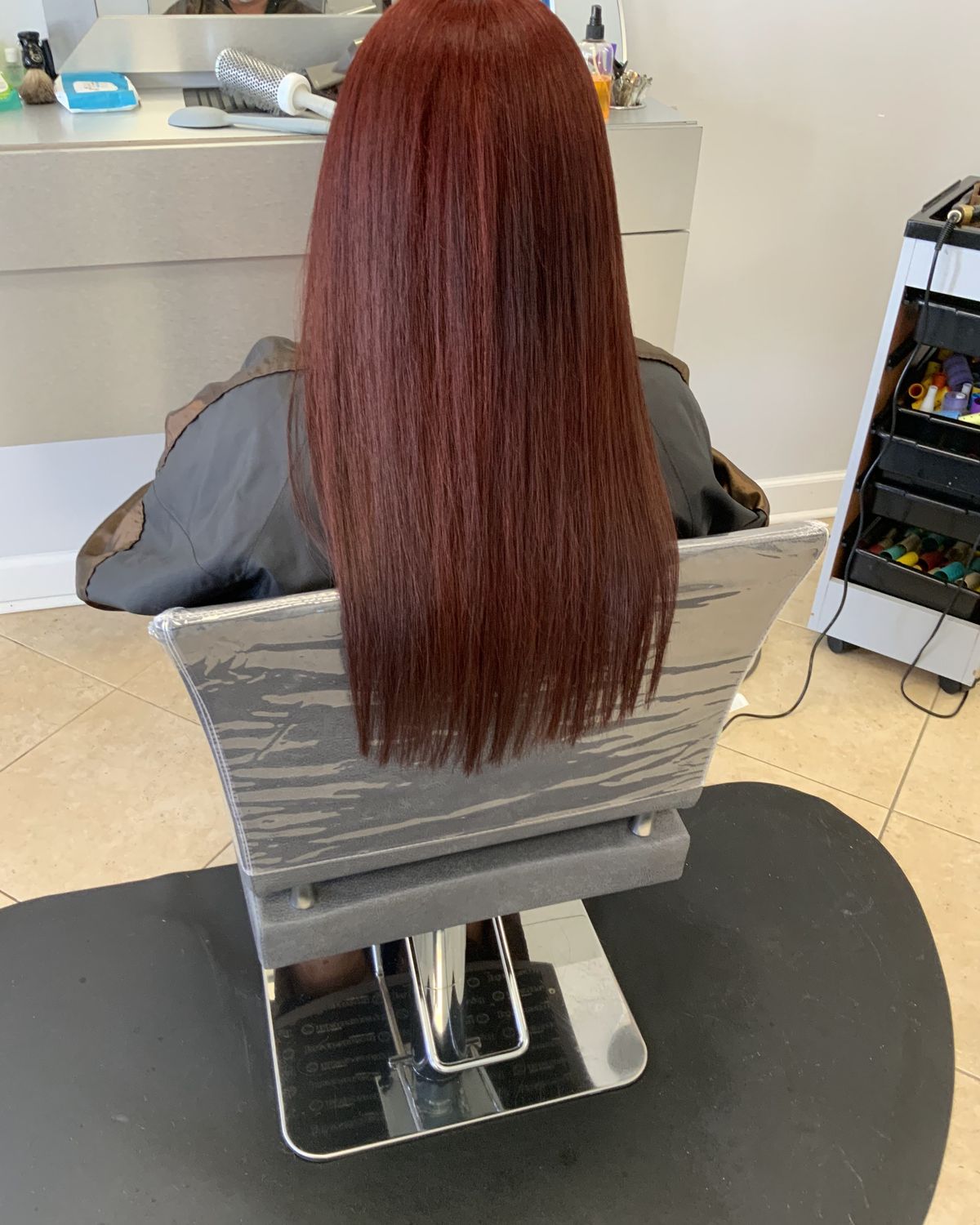 Deep red worn long and glossy — Touchée Organic Salon, Juno Beach