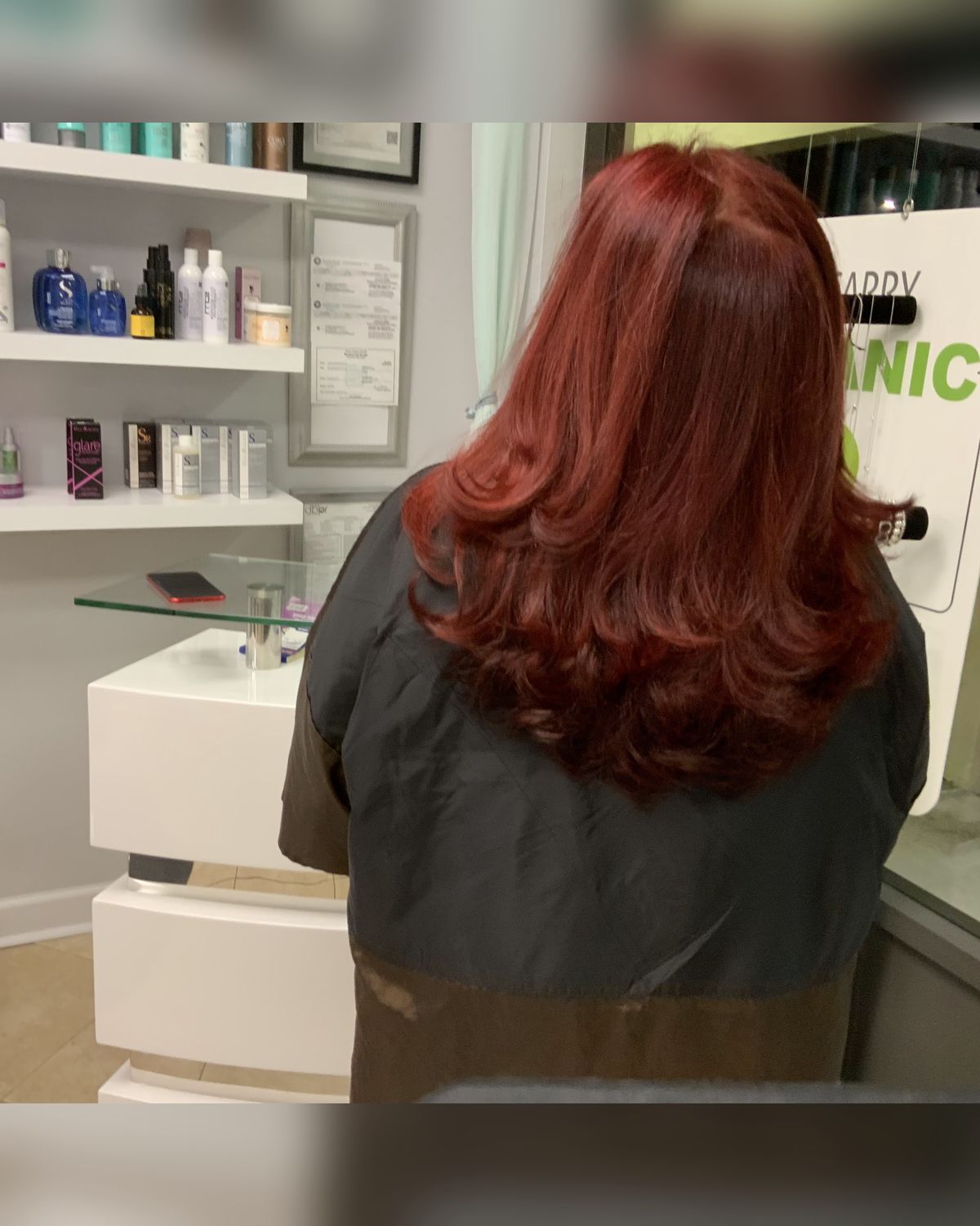 Deep red with dimension through the mid-lengths — Touchée Organic Salon, Juno Beach