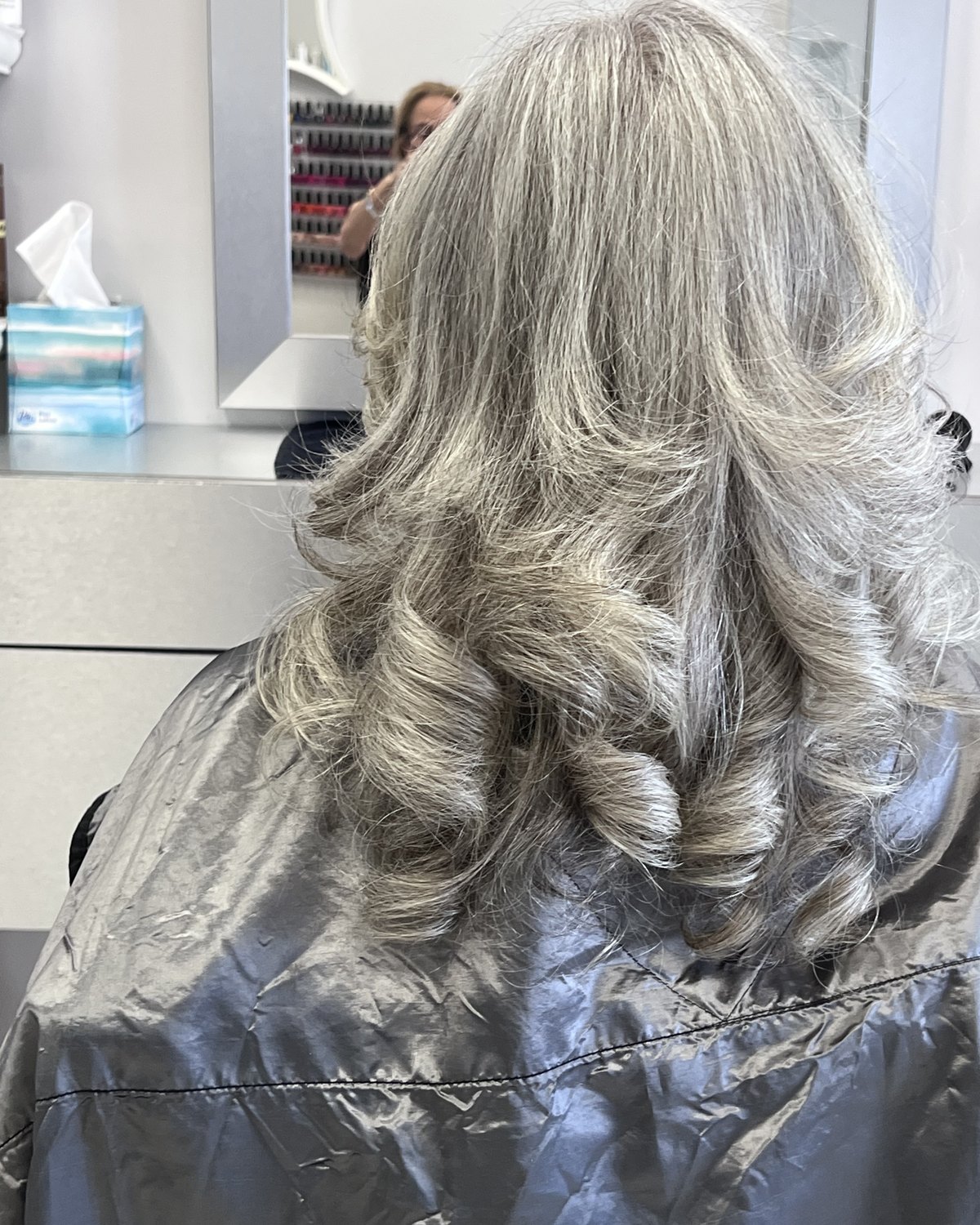 Long silver waves, gray worn as the color rather than covered